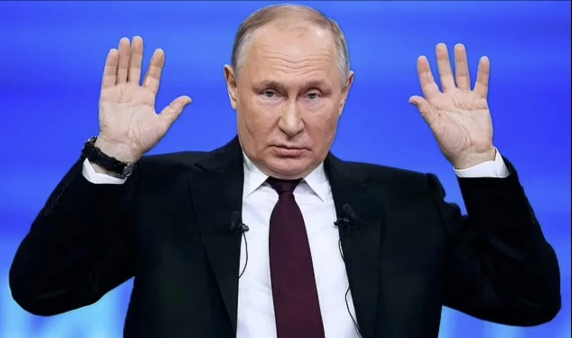 Володимир Путін у костюмі підняв обидві долоні вперед на синьому тлі
